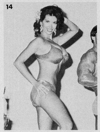 Kellie flashes a coy, seductive smile at the camera in red bikini body beautiful winning photo